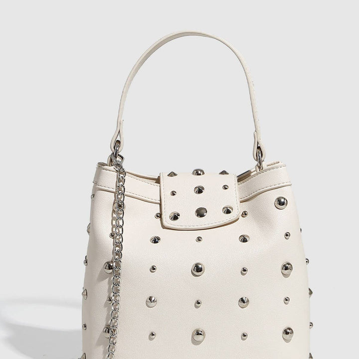 White studded mini shoulder bag with silver hardware and chain strap, shown with and without phone for size reference