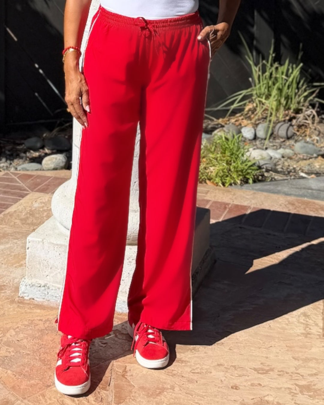 model wearing red Sideline Track Pant, close-up on waistband and drawstring detail