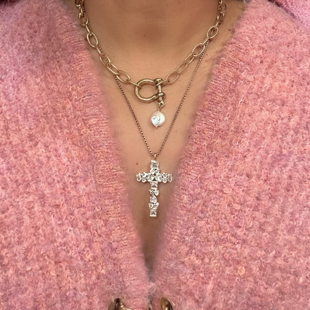 Necklace with a pearl necklace on a pink textured background