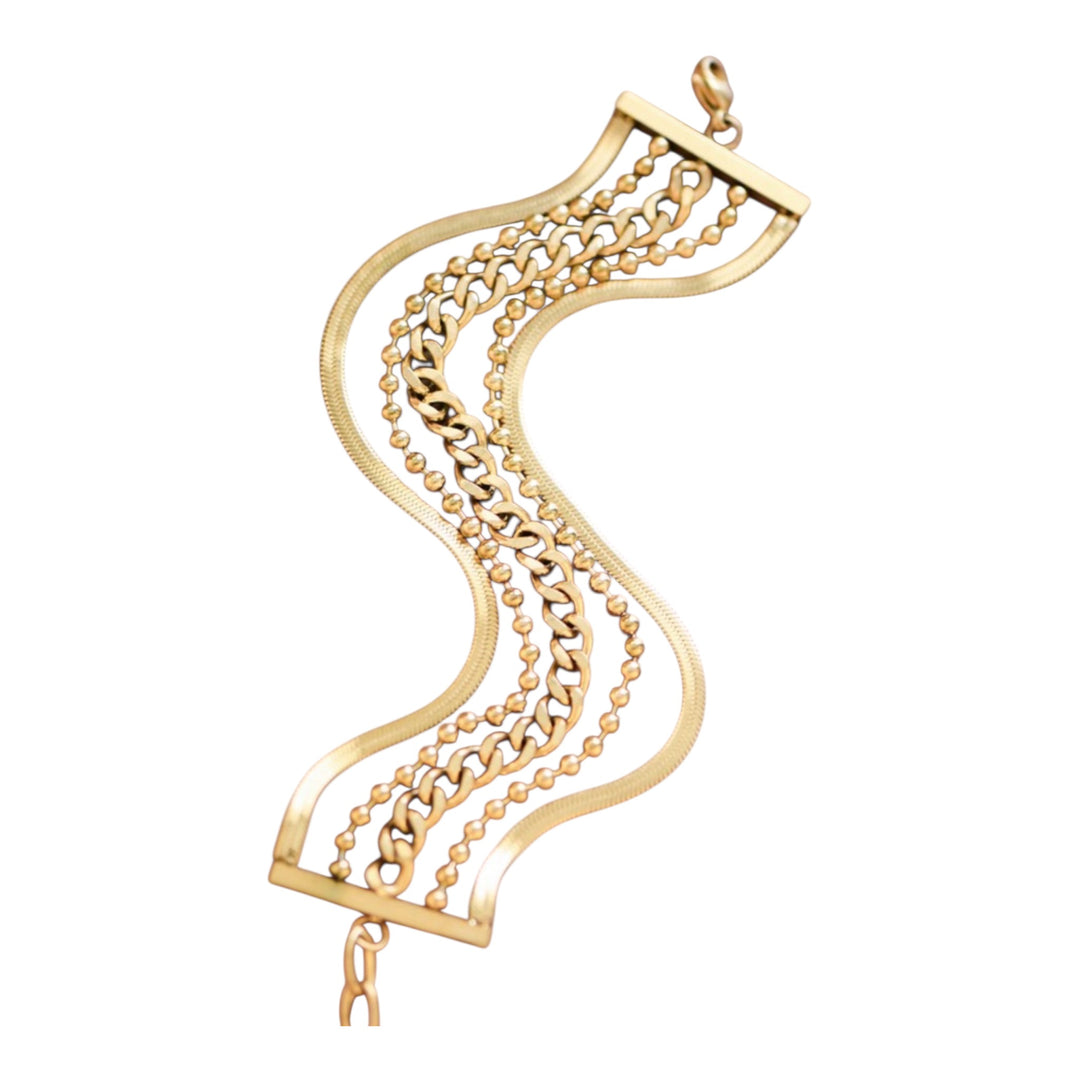 Gold multi chain bracelet with intricate design on a white background