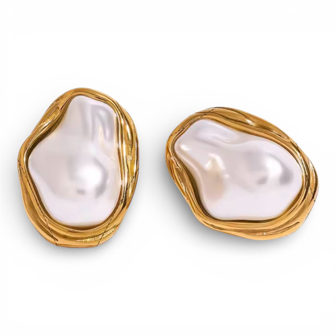 Pair of pearl earrings with gold frames on a white background