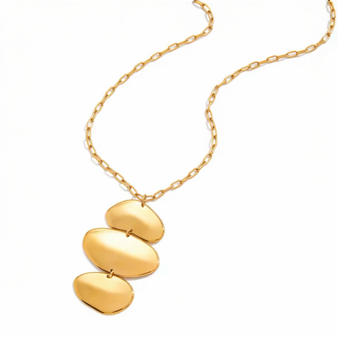 Gold necklace with three oval pendants on a white background