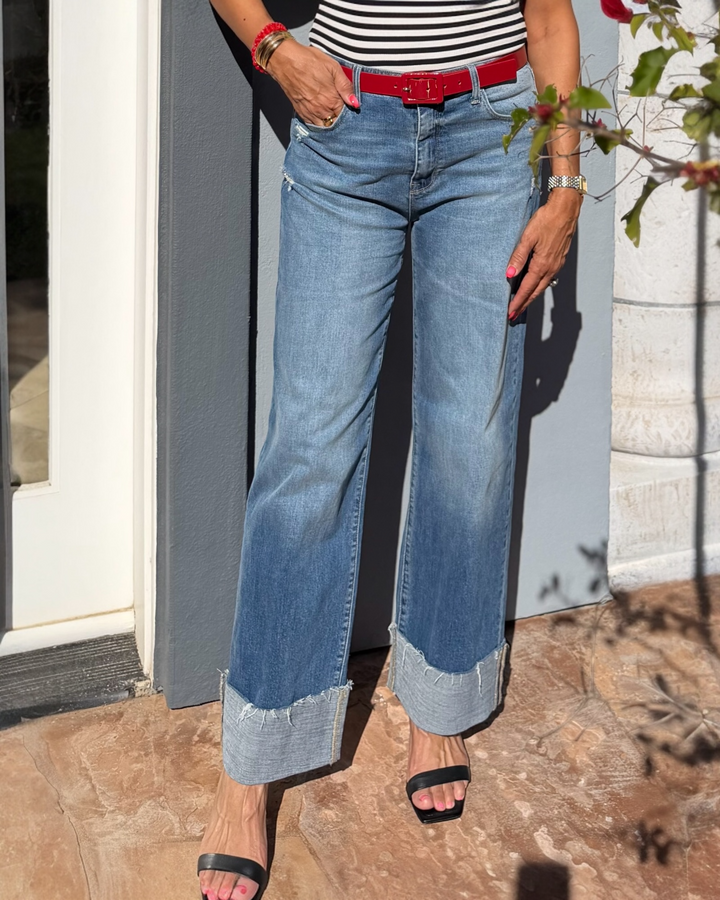 High rise loose straight leg jeans with 4.5 inch cuffed hem, medium wash comfort stretch denim, styled with black heels.