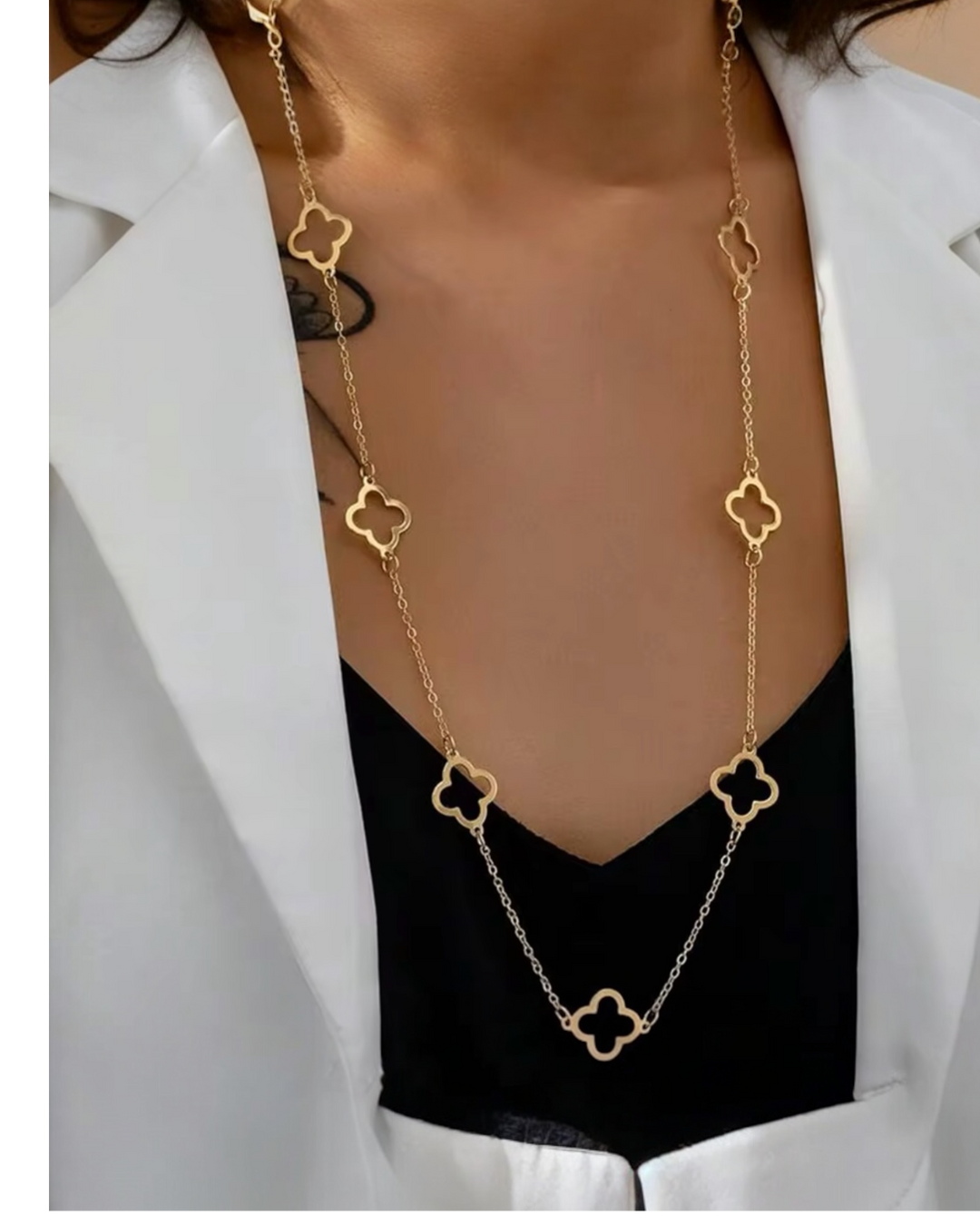 Gold and silver clover station necklace with long chain on model, stainless steel waterproof jewelry