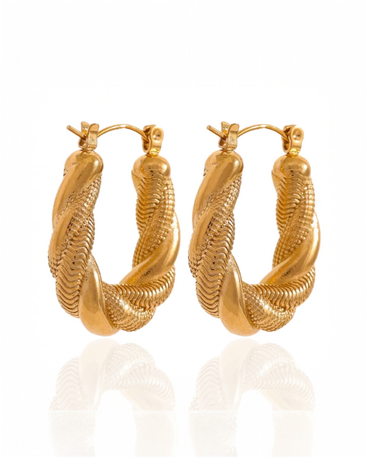 Gold hoop earrings on a white background