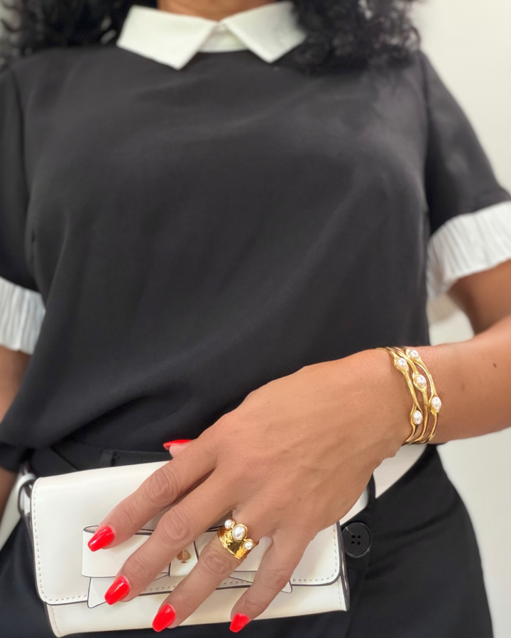 woman wearing pearl and gold bracelet
