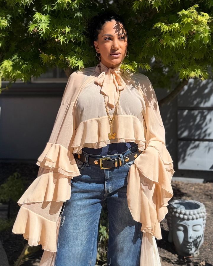 woman wearing a long sleeve ruffle blouse