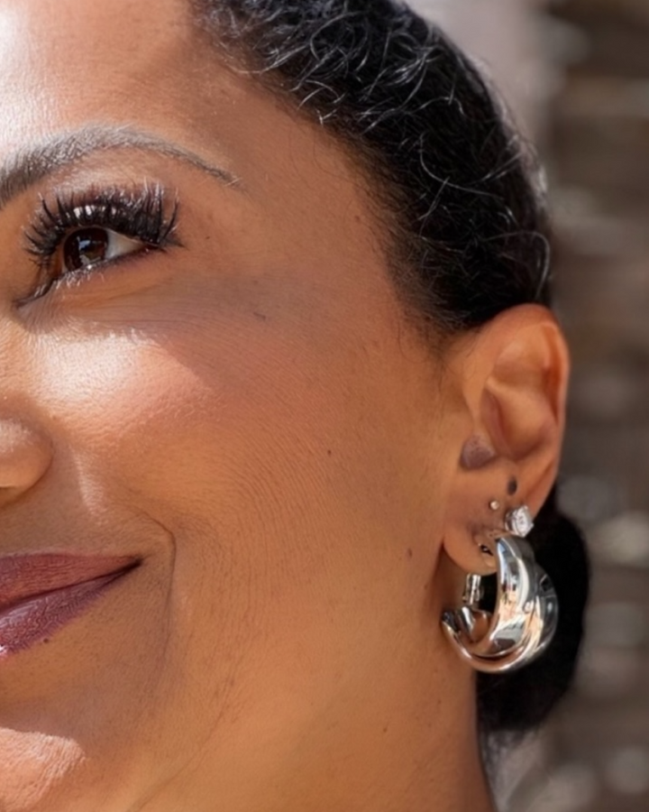 Silver chunky hoop earrings with high-shine finish, bold statement curved design