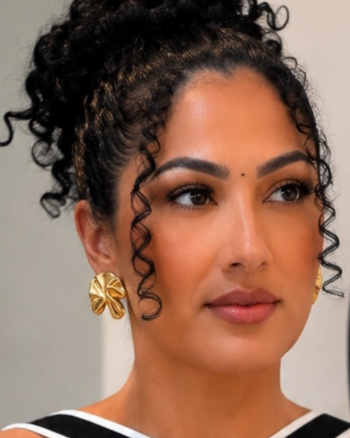 Gold and silver sculptural flower statement earrings with a polished metallic finish.