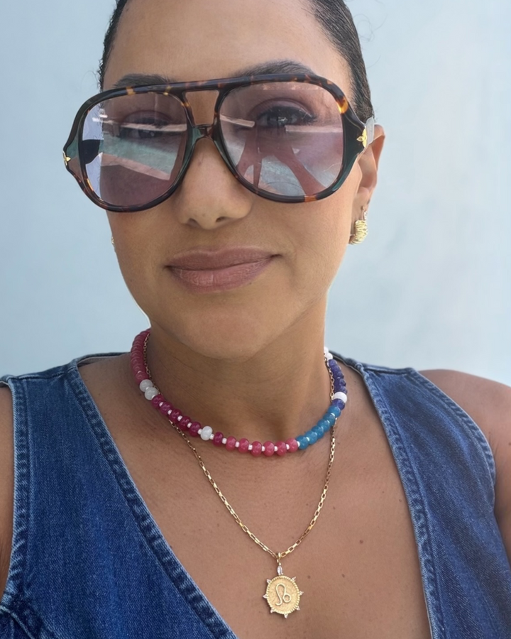 Smarties Necklace flat lay in multi colorway featuring red, green, blue, tan, and white natural agate gemstone beads with gold clasp