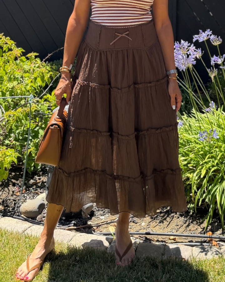 Close-up of brown tiered maxi skirt with lace trim waist detail