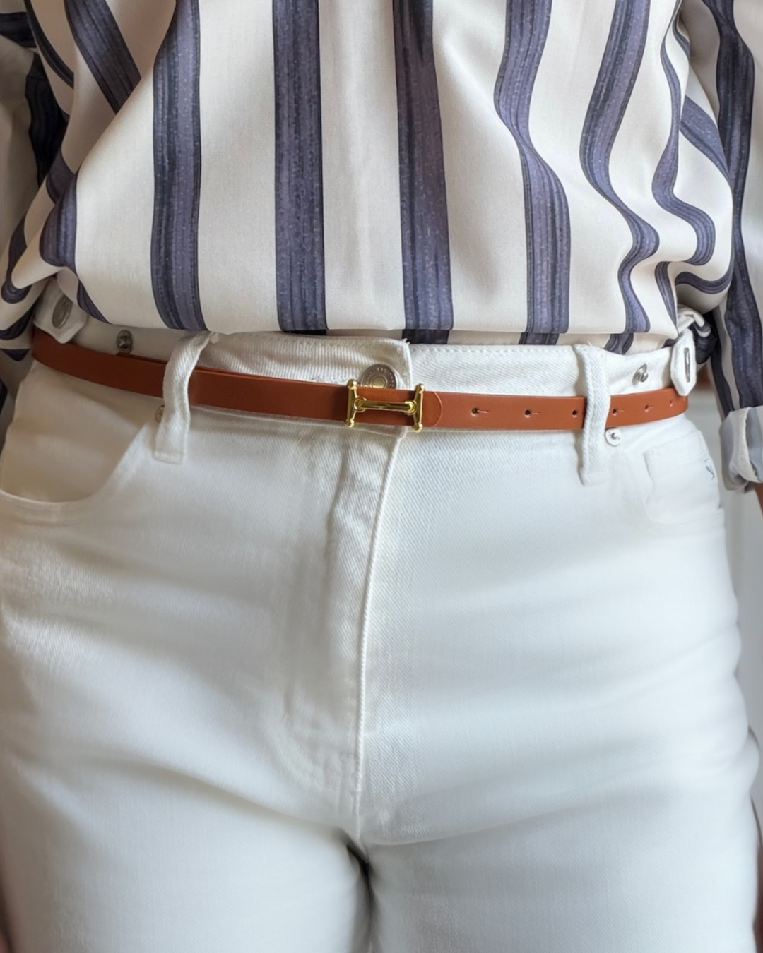 Cognac Georgia Belt with gold H-hardware buckle laid flat