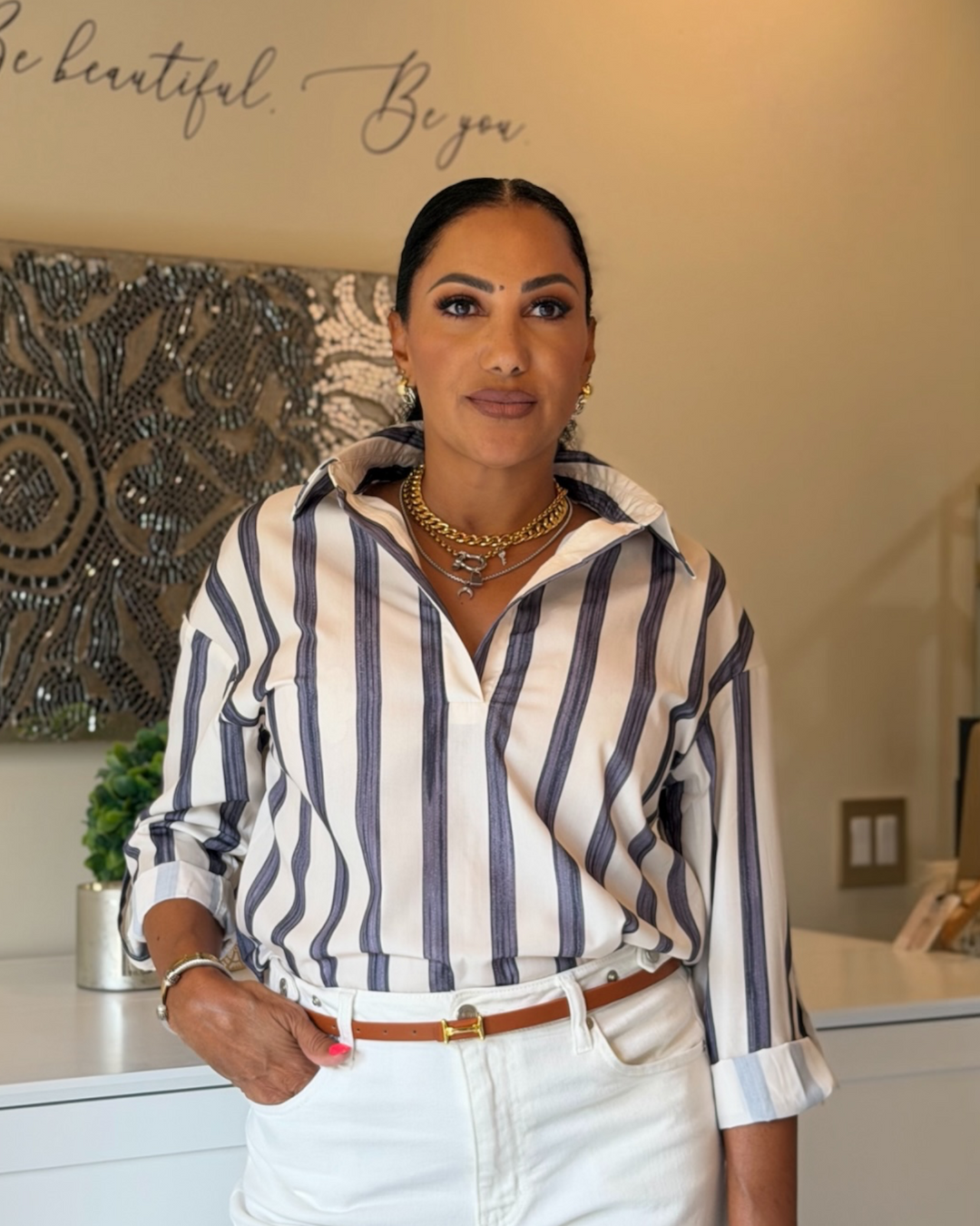 Woman wearing blue and white stripe Rowan Stripe Top with white denim