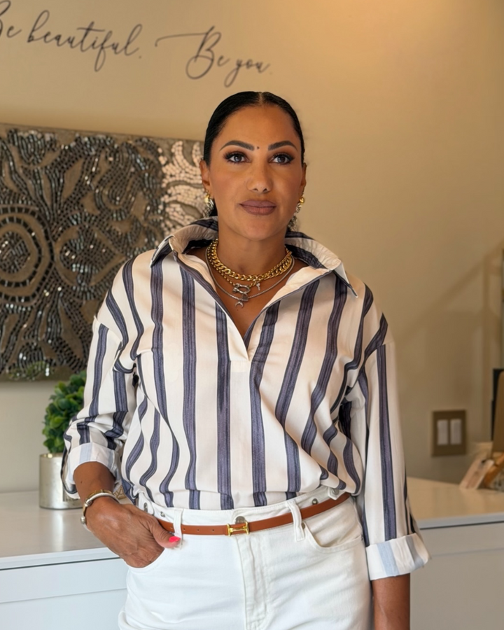 Woman wearing blue and white stripe Rowan Stripe Top with white denim